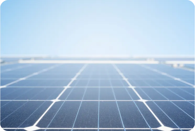 Close-up view of dark blue solar panels under clear blue sky.