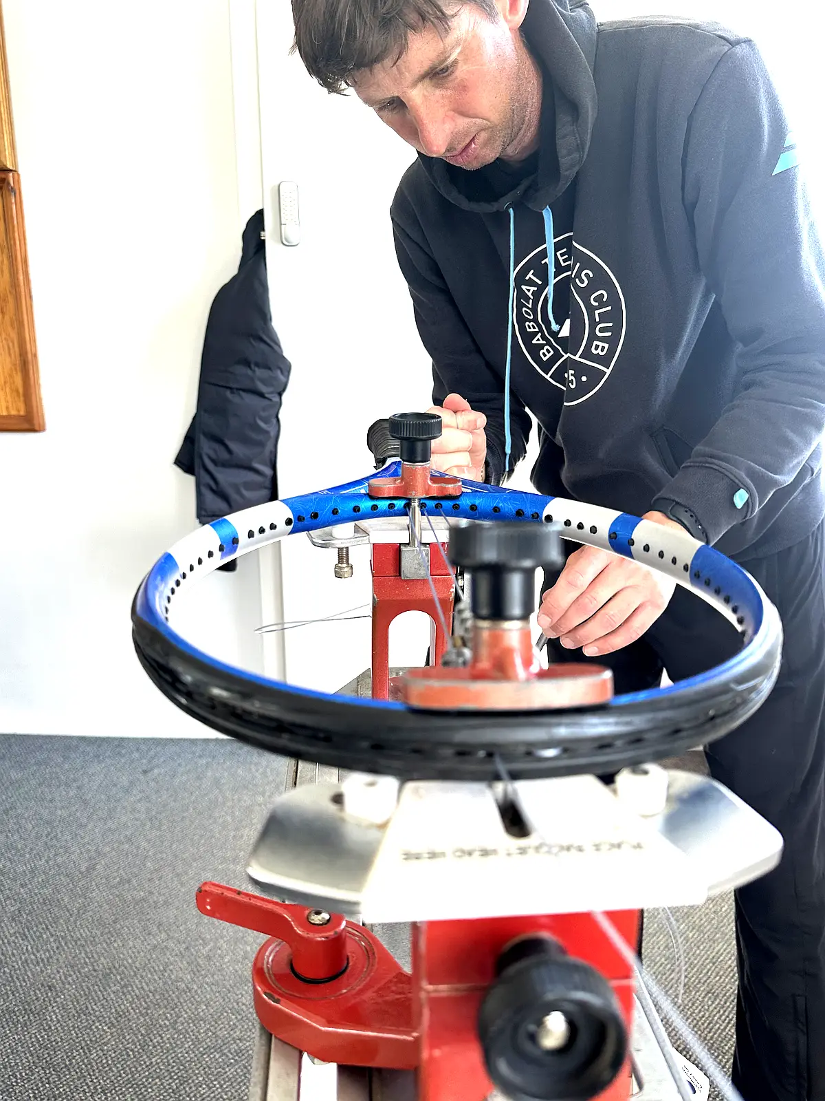 Matt Sanger stringing a racket