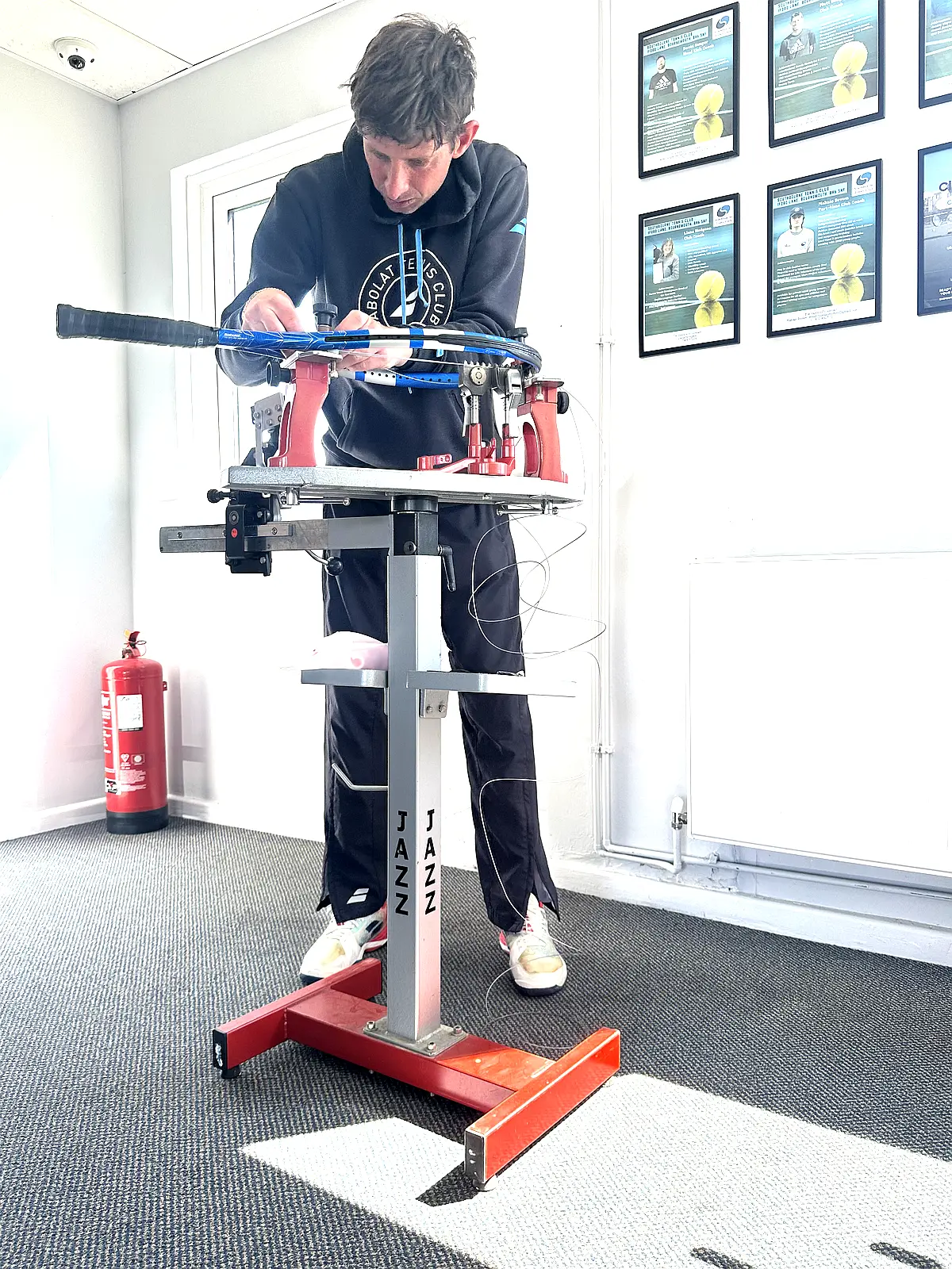 Matt Sanger stringing a racket at Southbourne Tennis Club