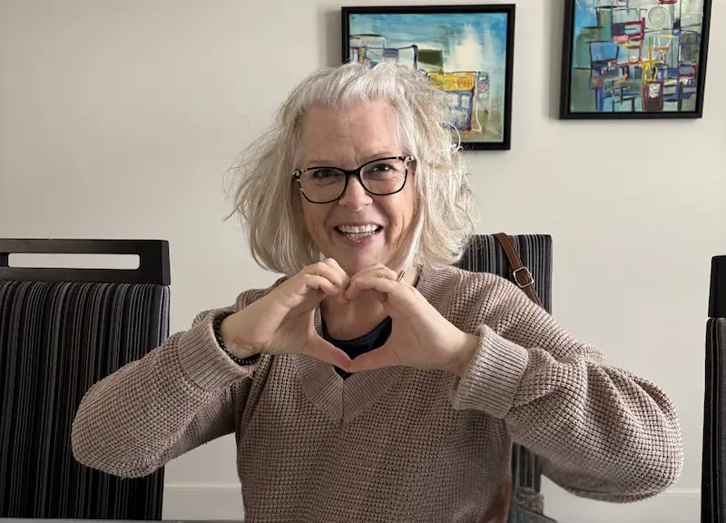 Woman making a heart shape with her hands