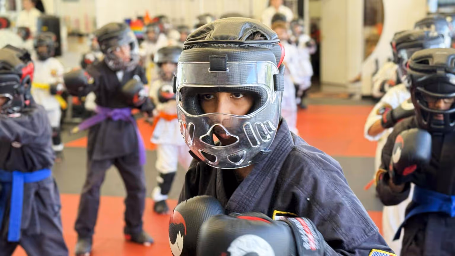 Karate Instructor teaching a student how to do a side kick