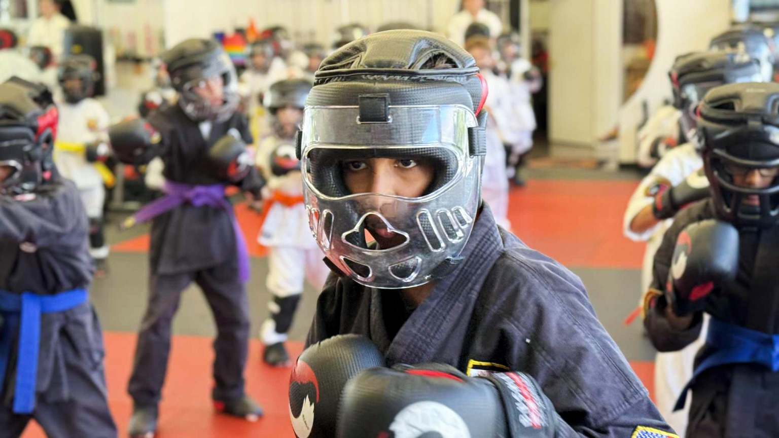 Karate Instructor teaching a student how to do a side kick