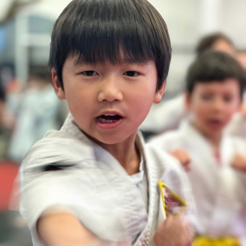 Woman in t-shirt participating in Self Defense Class.