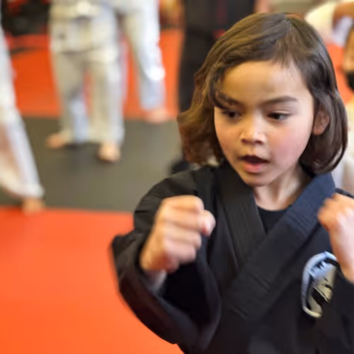 Woman in t-shirt participating in Self Defense Class.