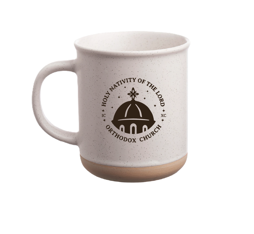 White speckled ceramic mug with a wooden base and handle, featuring a black logo of a church dome with a cross and the text 'Holy Nativity of the Lord Orthodox Church' surrounding it.