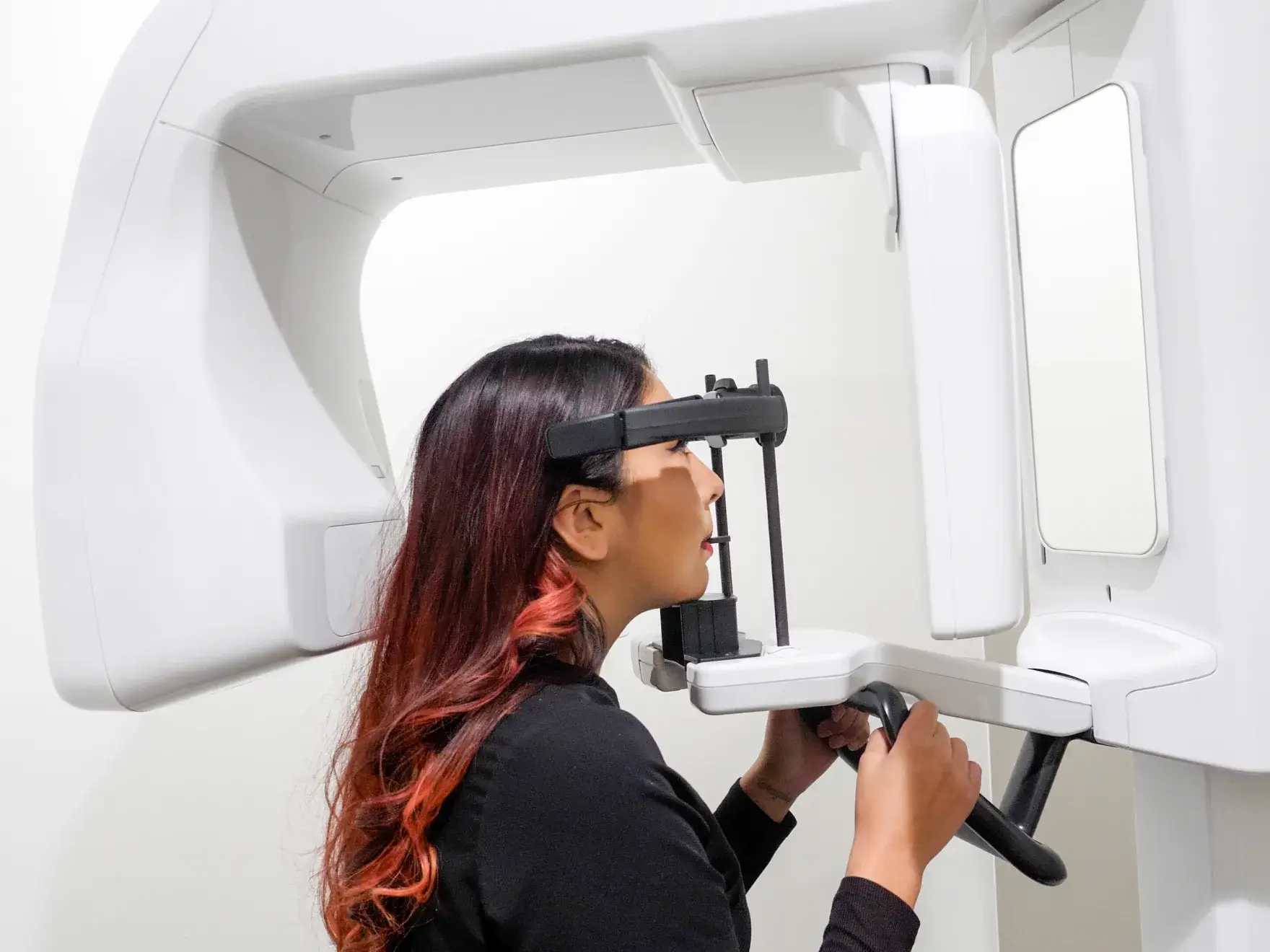 Two people in black uniforms are giving each other a high-five against a brick wall.