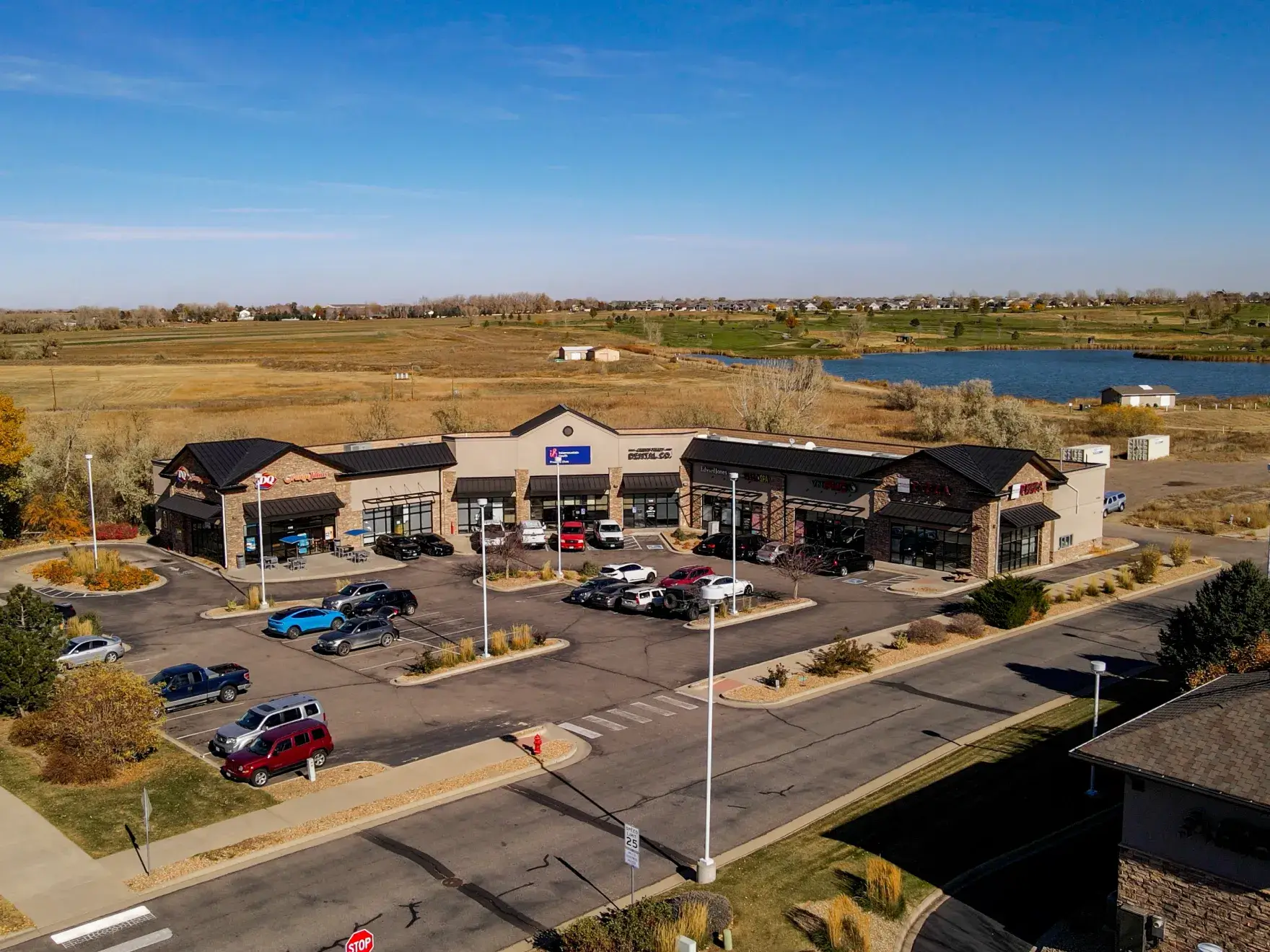 A dental X-ray machine mounted on a wall in a clean, white room.