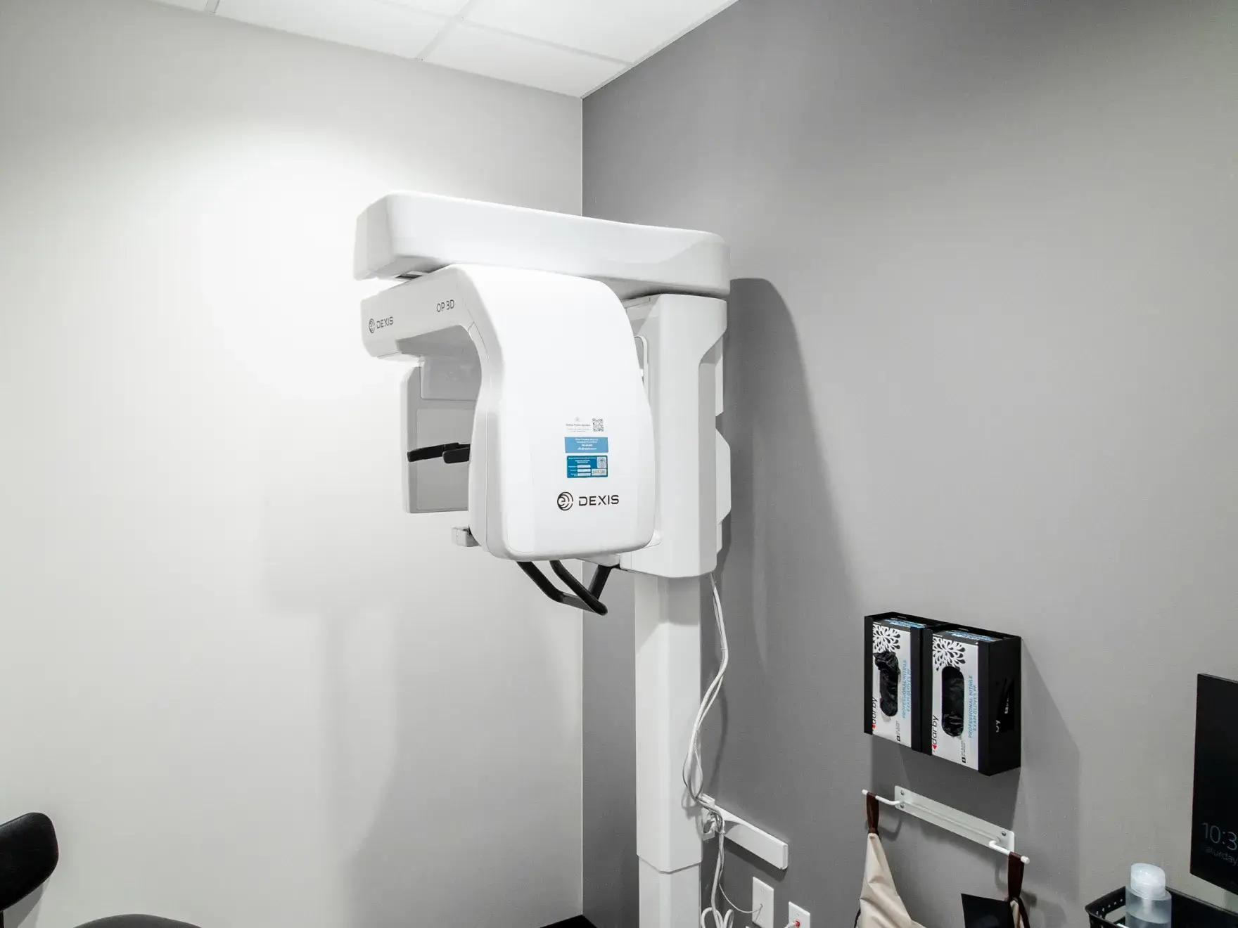 A woman with long red hair smiles while sitting at a desk with a computer.