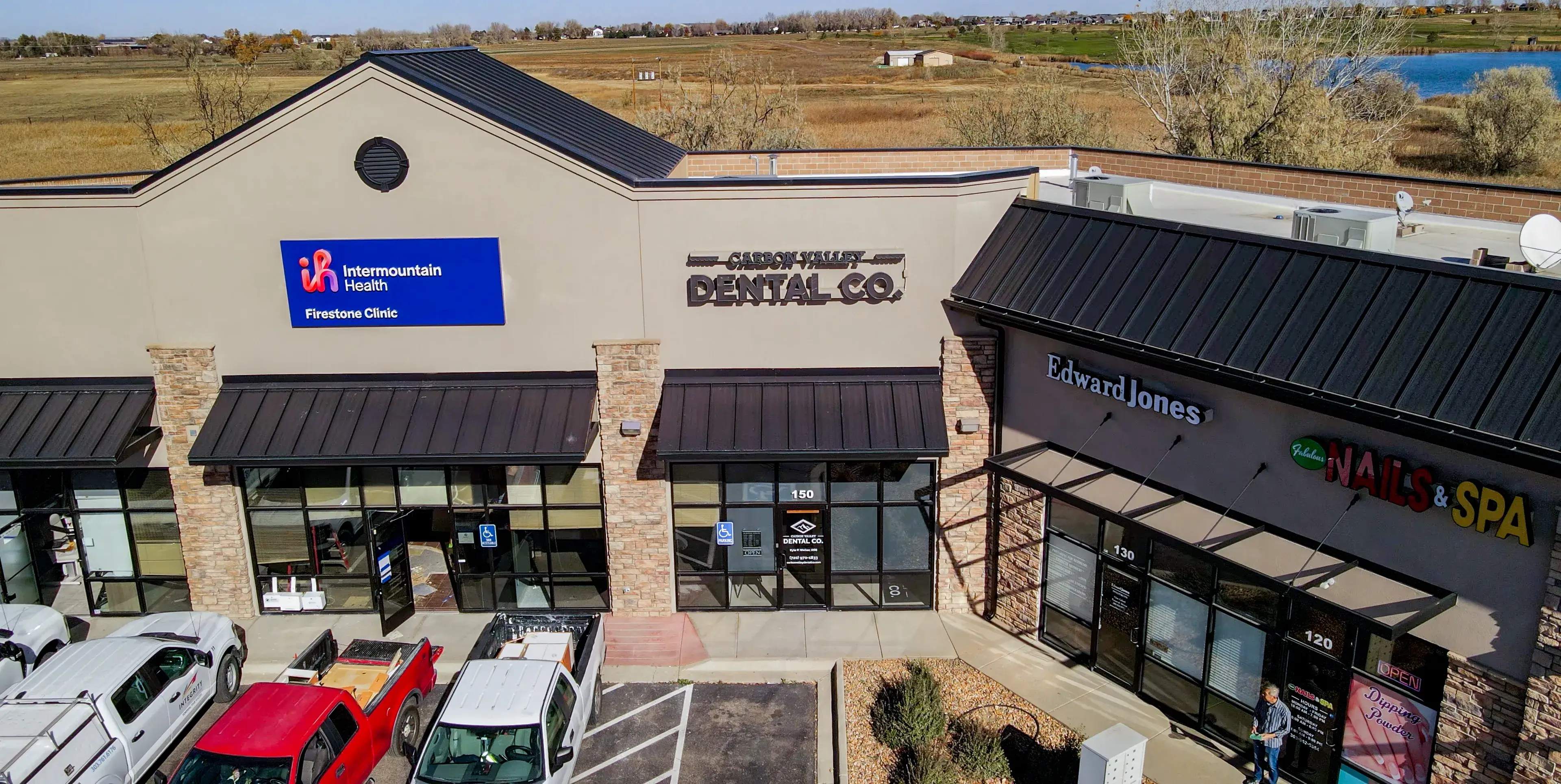 A person explains a digital model of teeth to a woman at a dentist's office.