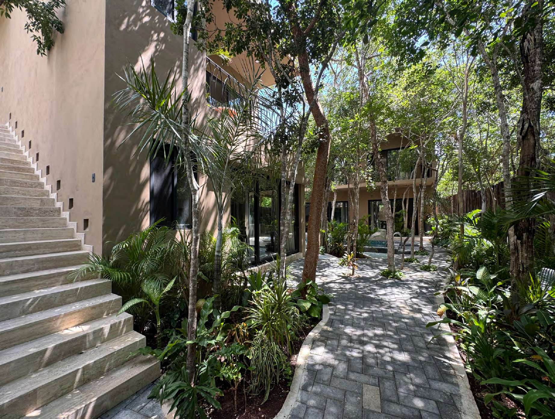Garden walk and travertine stair at House Yaxche, Casa Verde Tulum