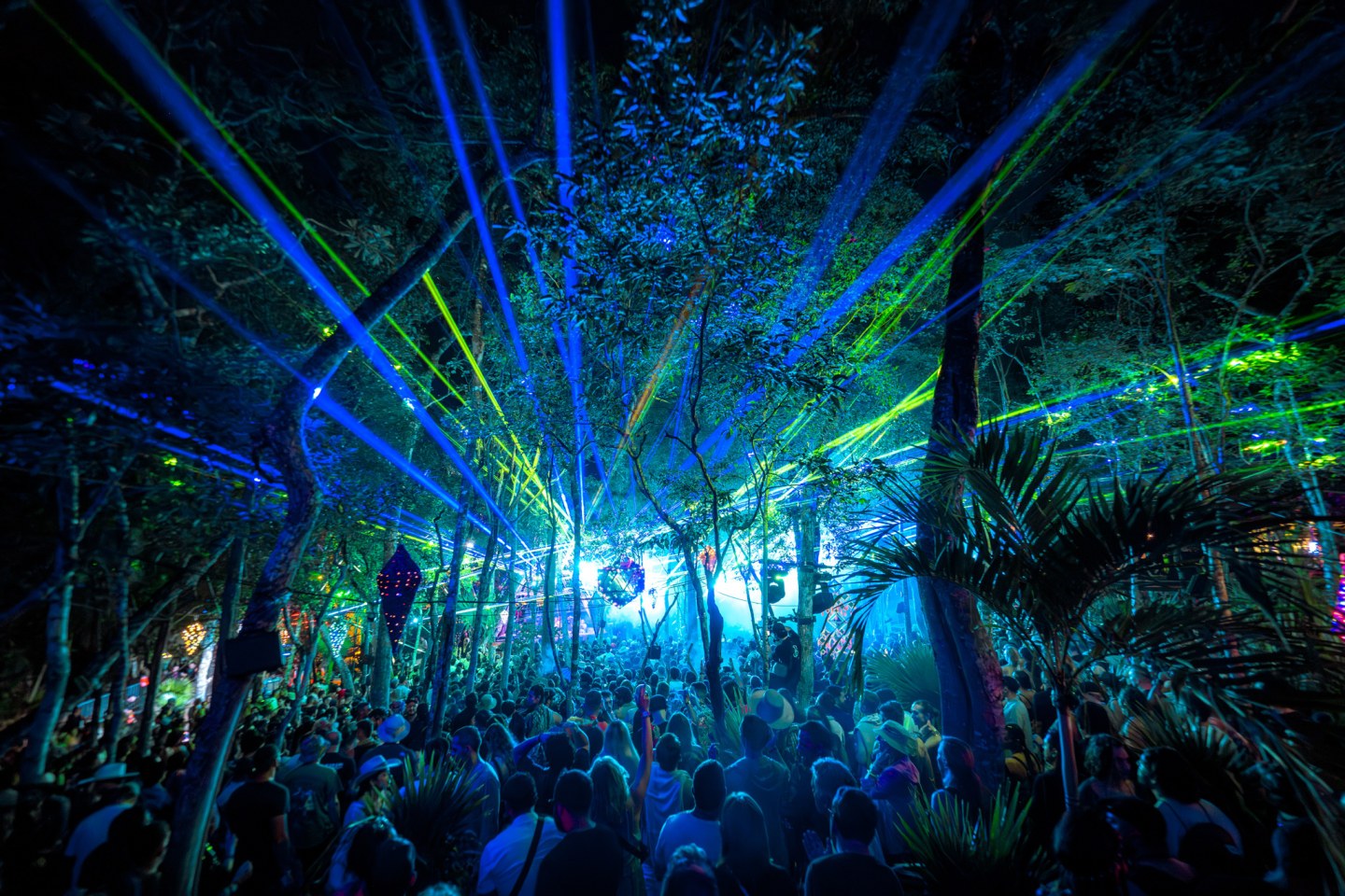 A Tulum jungle festival lit with lasers at night