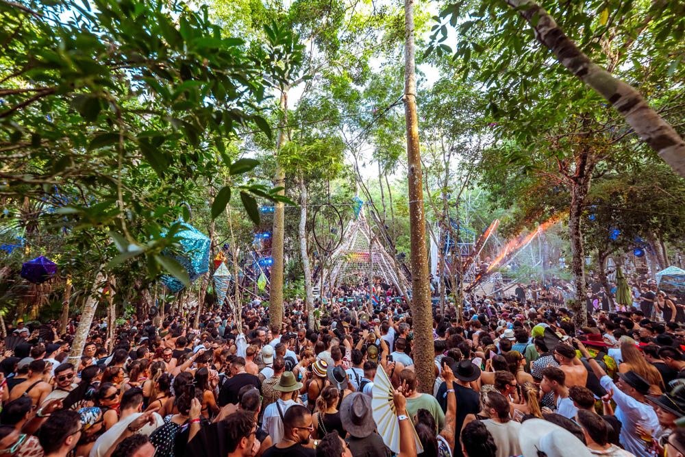 A daytime jungle day party crowd in Tulum
