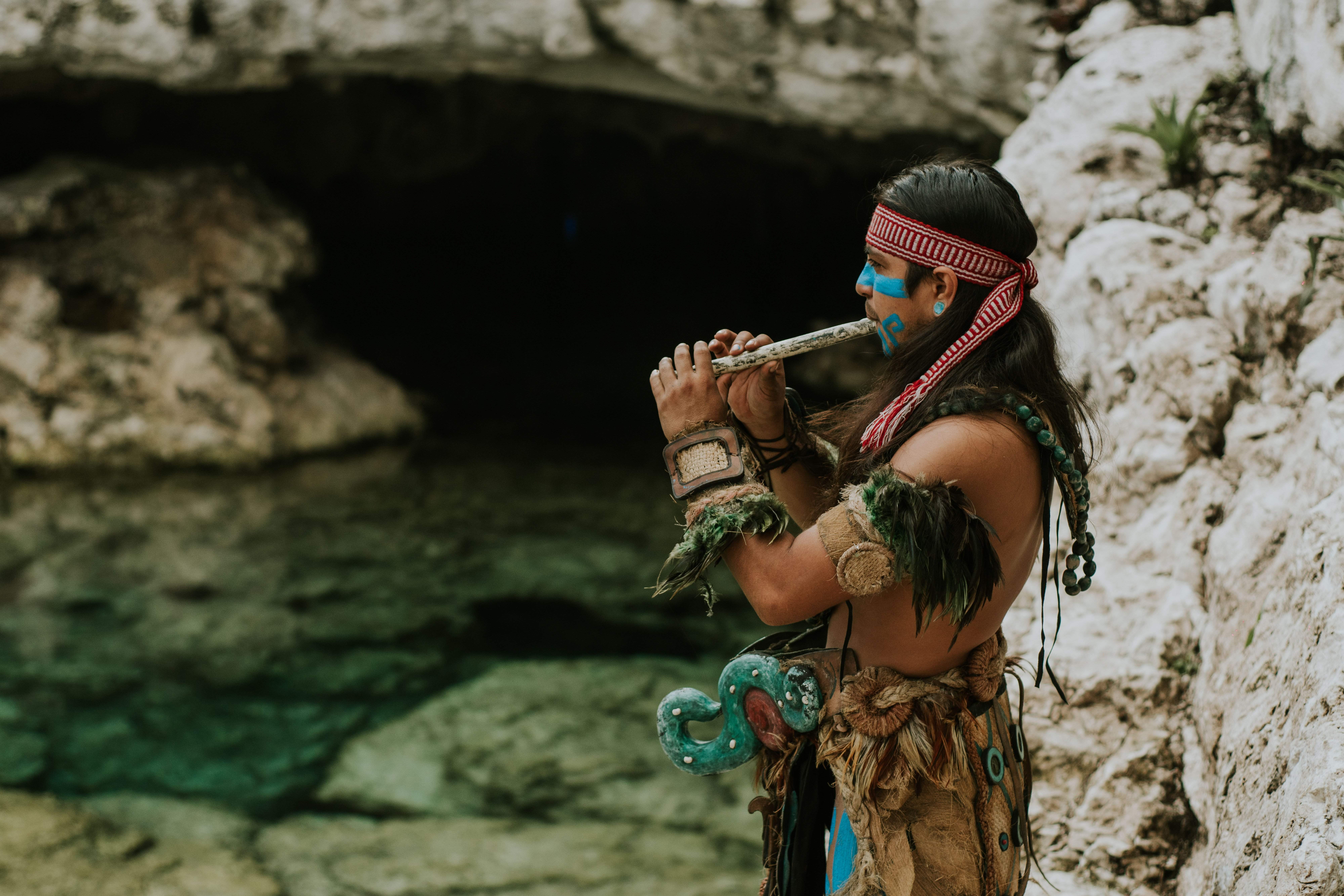 A musician playing beside a Tulum cenote