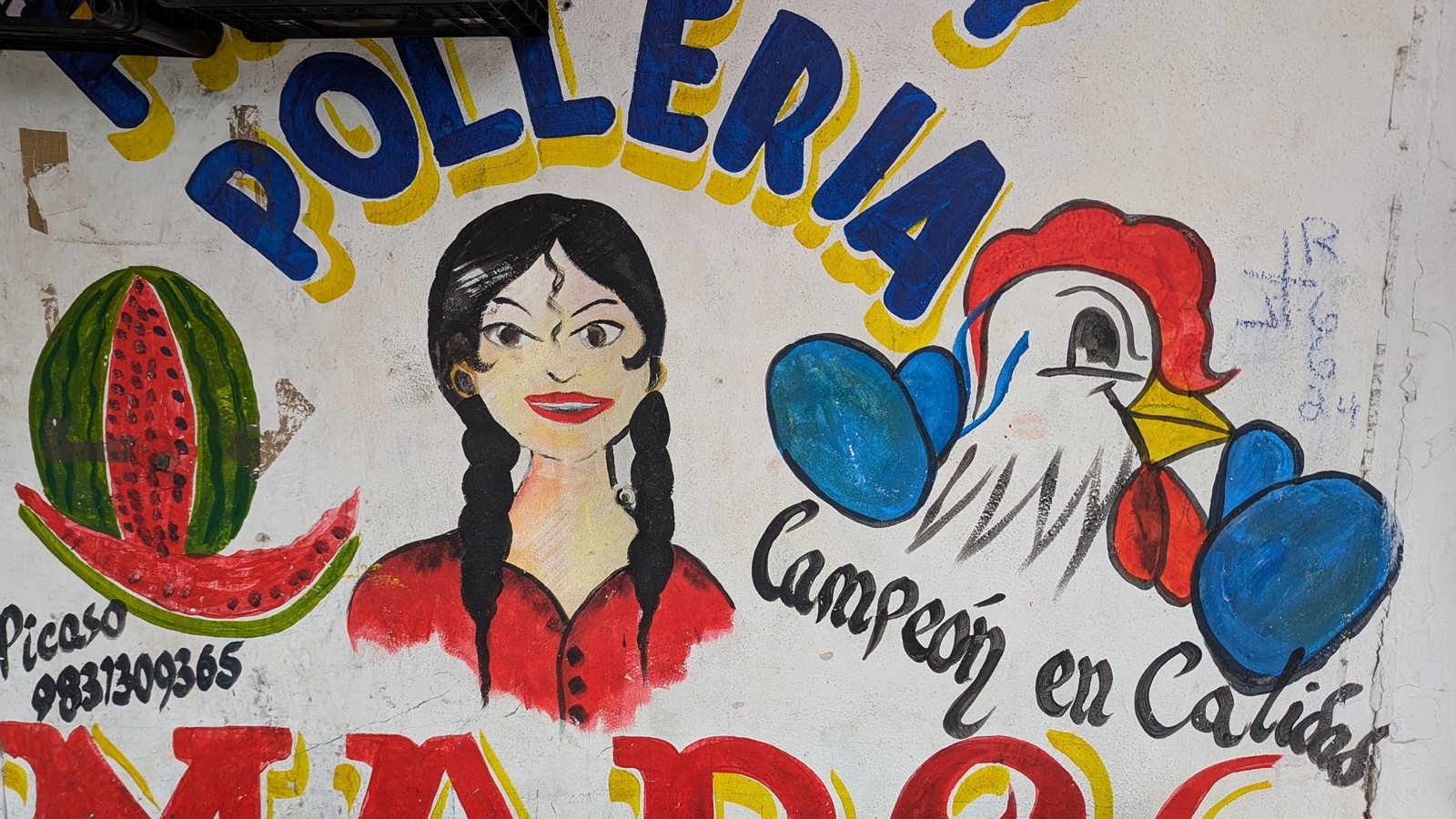 A hand-painted pollería sign in Tulum reading Campeon en Calidad, with a painted woman and rooster