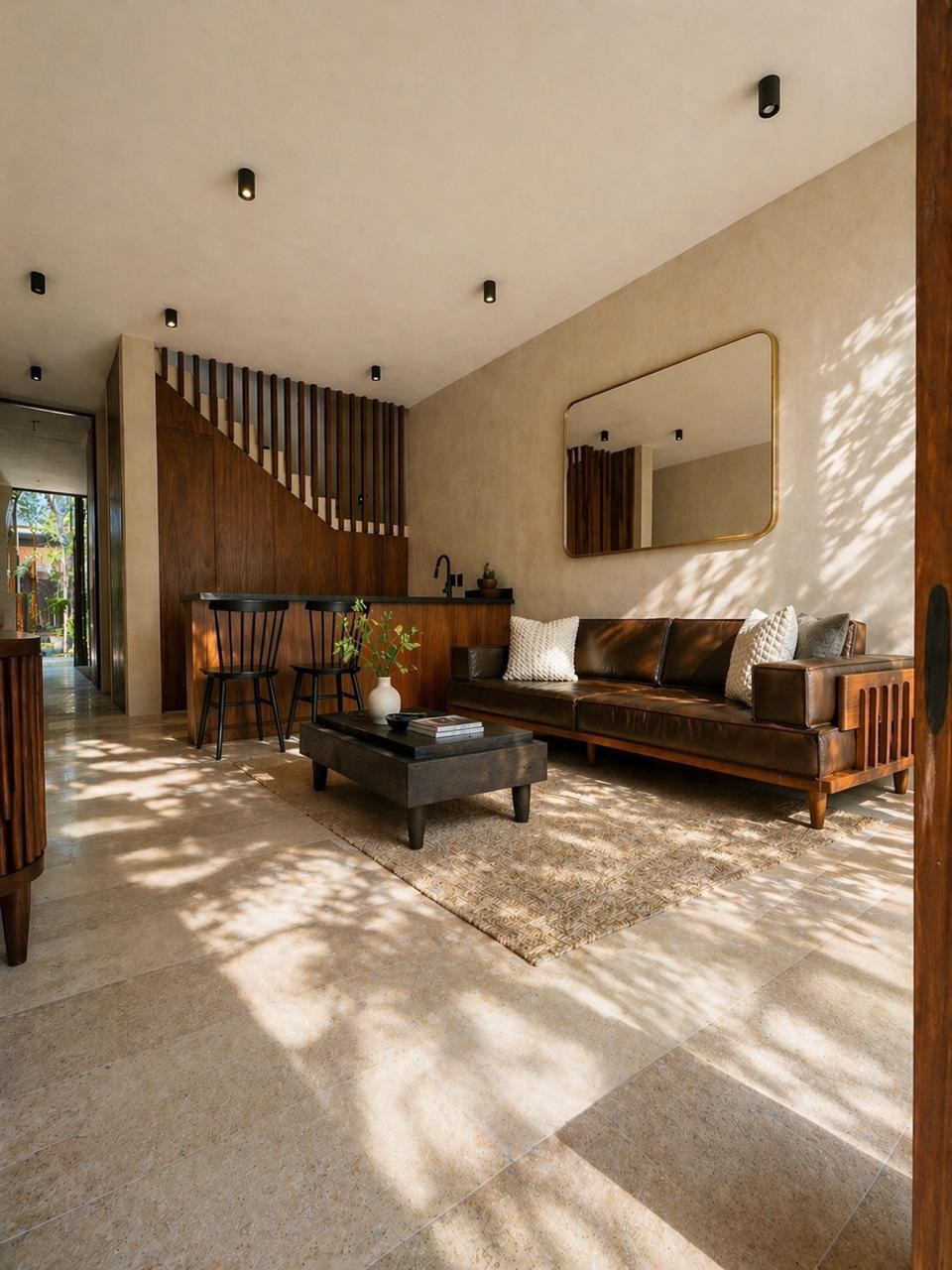 Living room with sofa, low table and staircase, sunlight across the floor