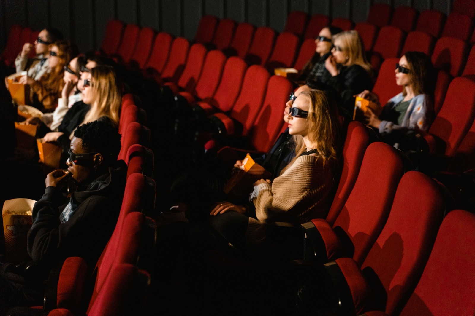 An audience seated in a cinema auditorium watching the screen
