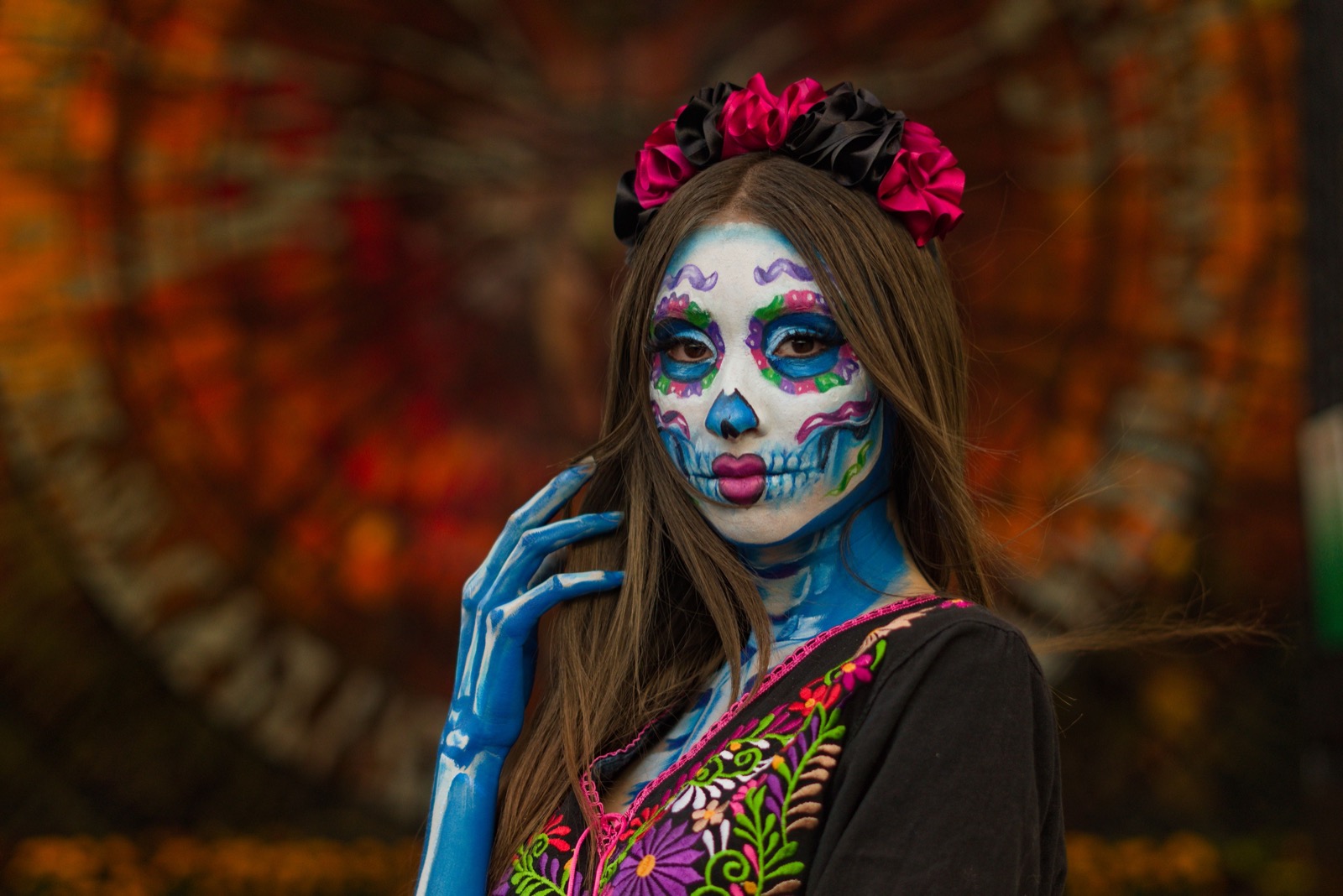 La Catrina face paint, flower crown and embroidered dress of the Día de los Muertos season