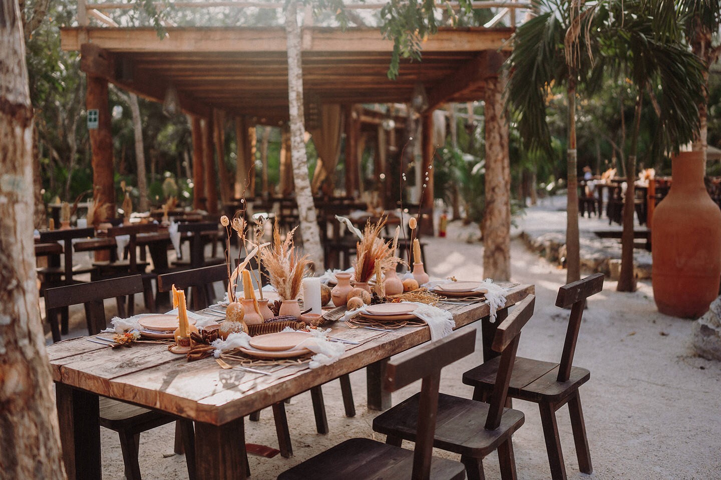 Restaurant table laid under the palapa