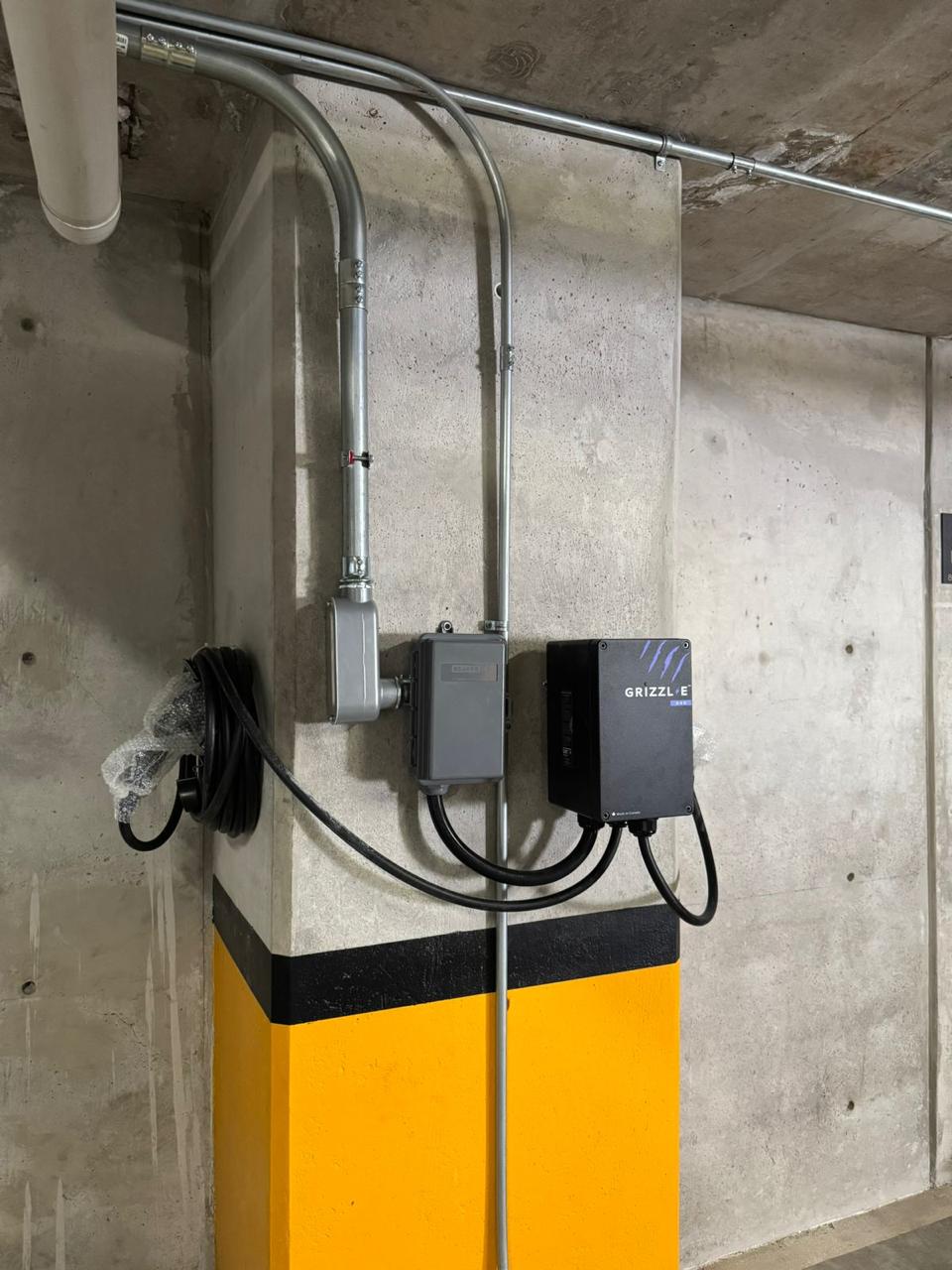 Electric vehicle charging point installed in a building parking structure