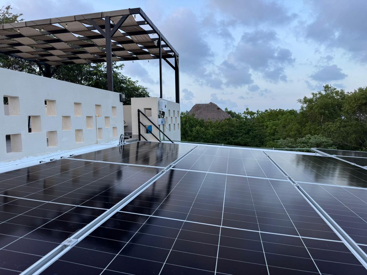 Rooftop terrace with pergola and solar panels at a Tulum villa