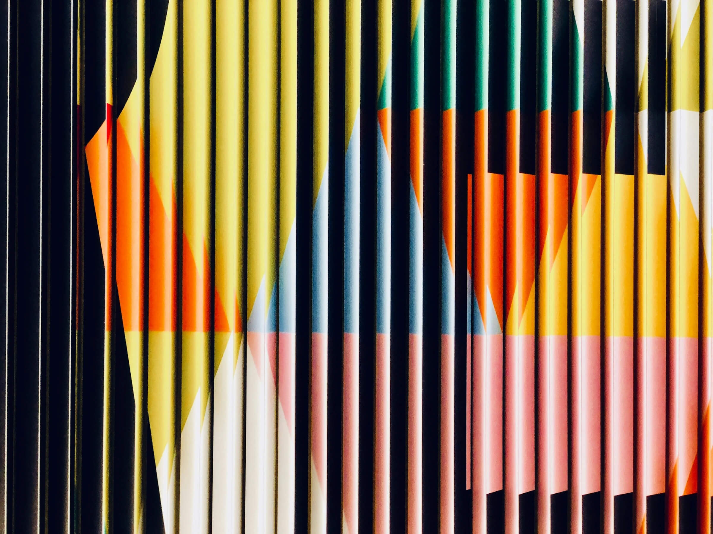 A vibrant abstract painting featuring a variety of colors set against a deep black background.