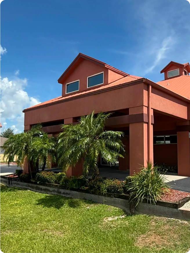 Exterior view of Cape Clarity Integrative Psychology office in Florida with palm trees and a welcoming entrance.