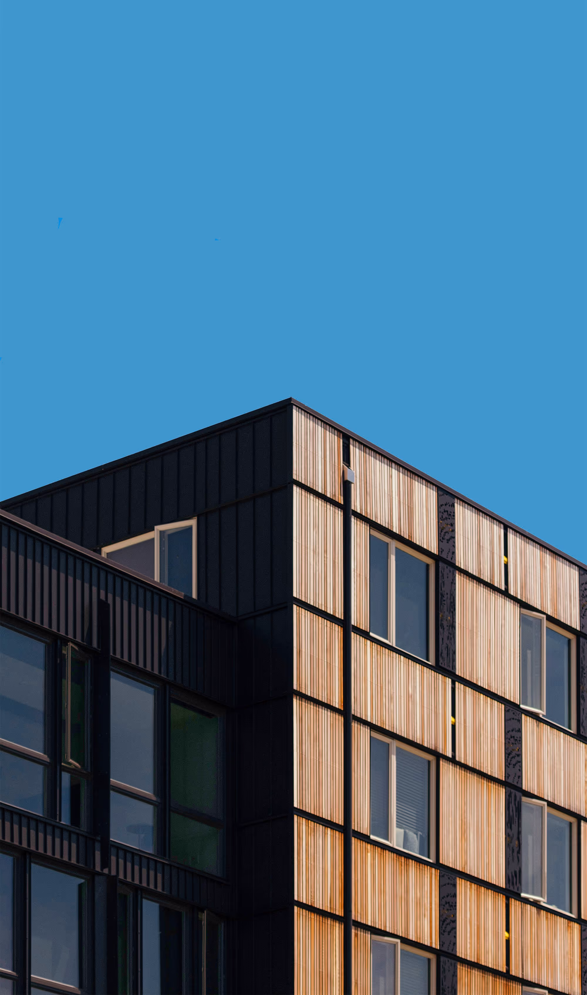 Modern home featuring sharp geometric shapes, an open floor plan, and a combination of glass, wood, and concrete materials for a stylish, minimalist look.