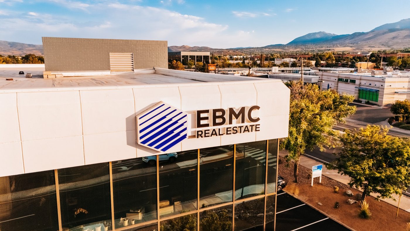 EBMC Real Estate Reno office exterior with updated signage, overlooking the Reno skyline and surrounding mountains.