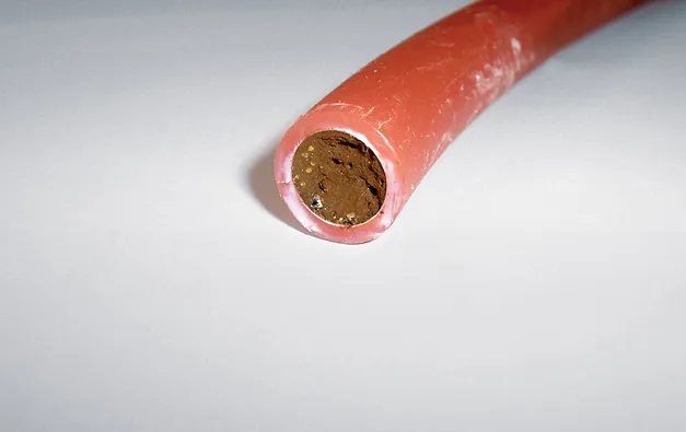 A close up of a piece of orange plastic.