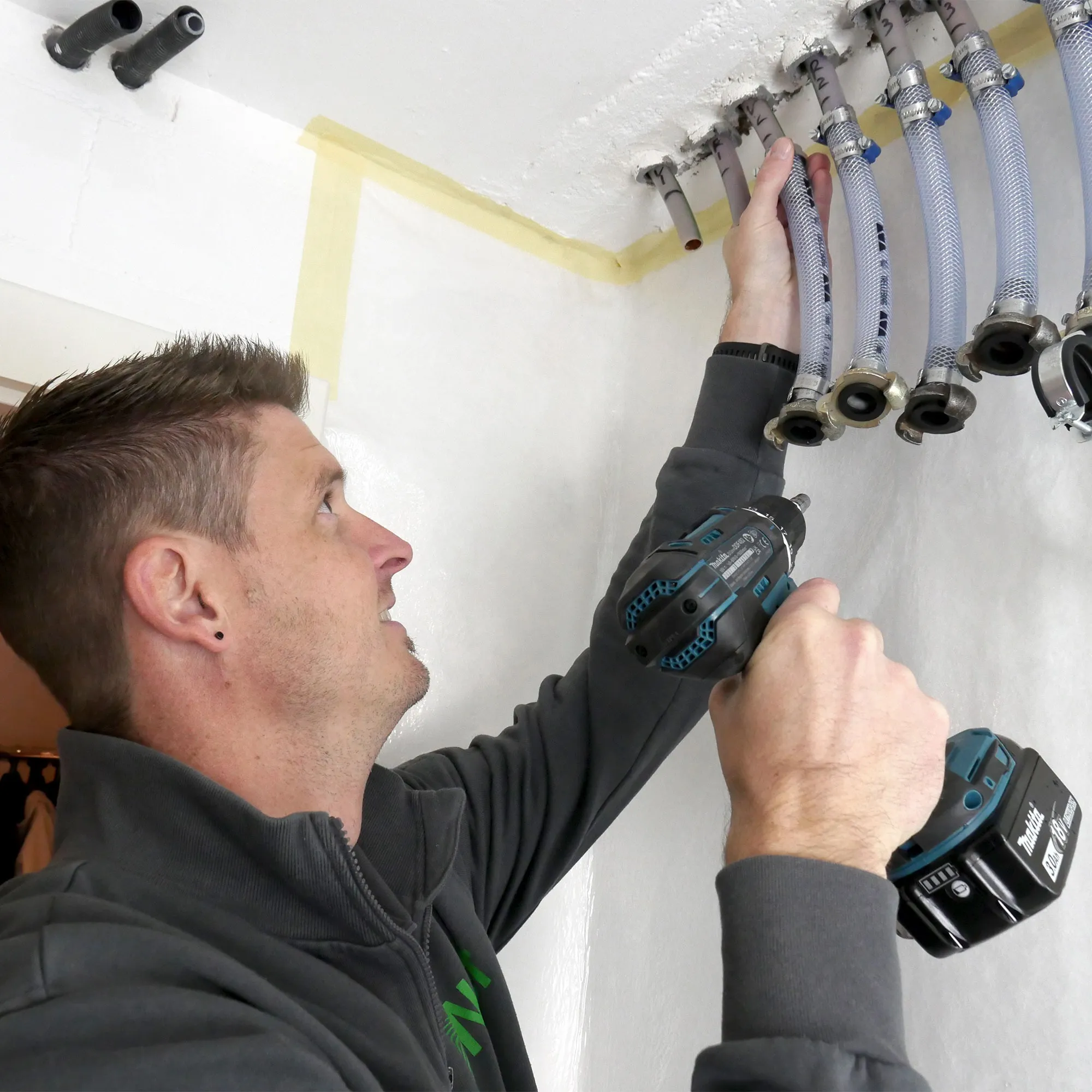 A man working on a ceiling fixture.