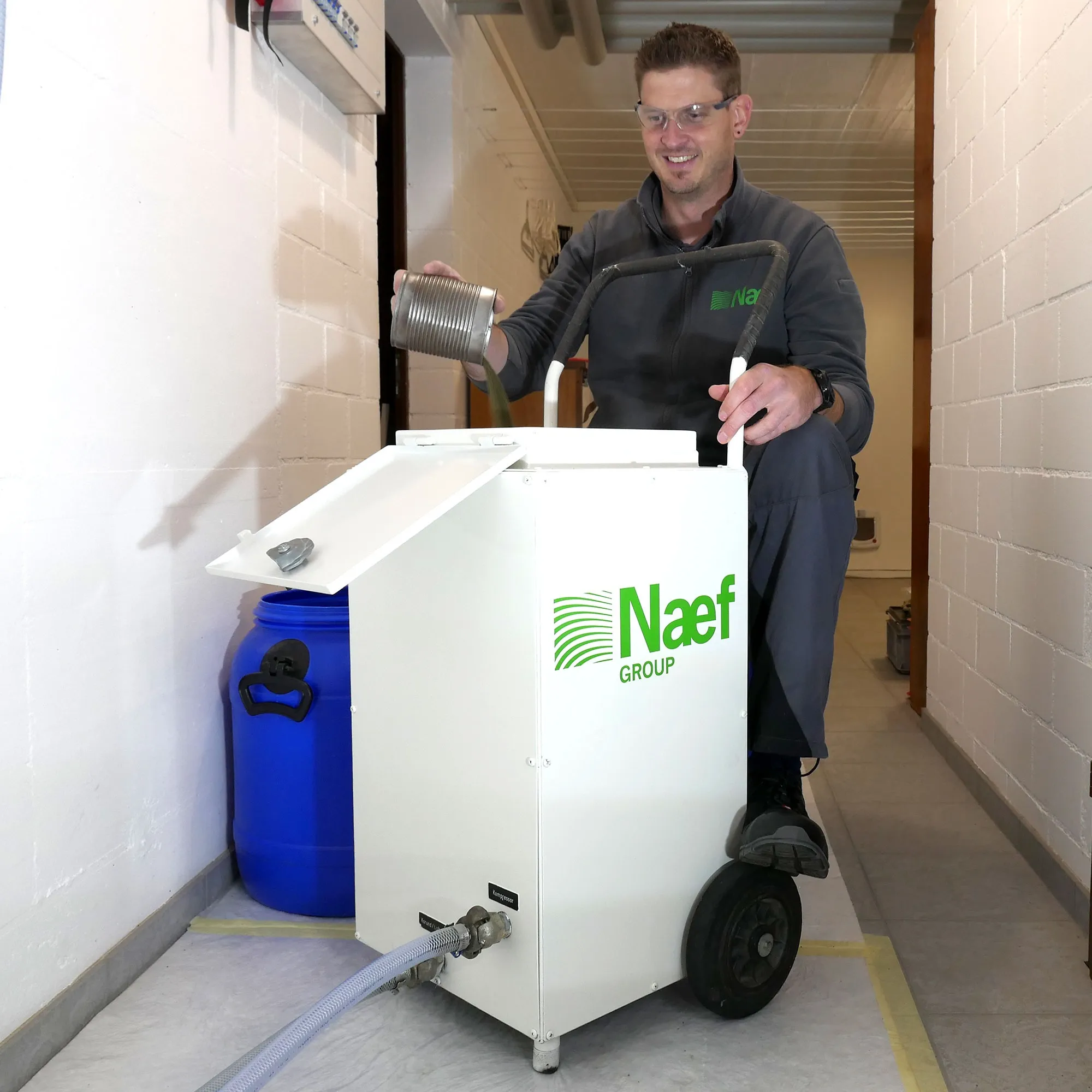 A man sitting on top of a white machine.