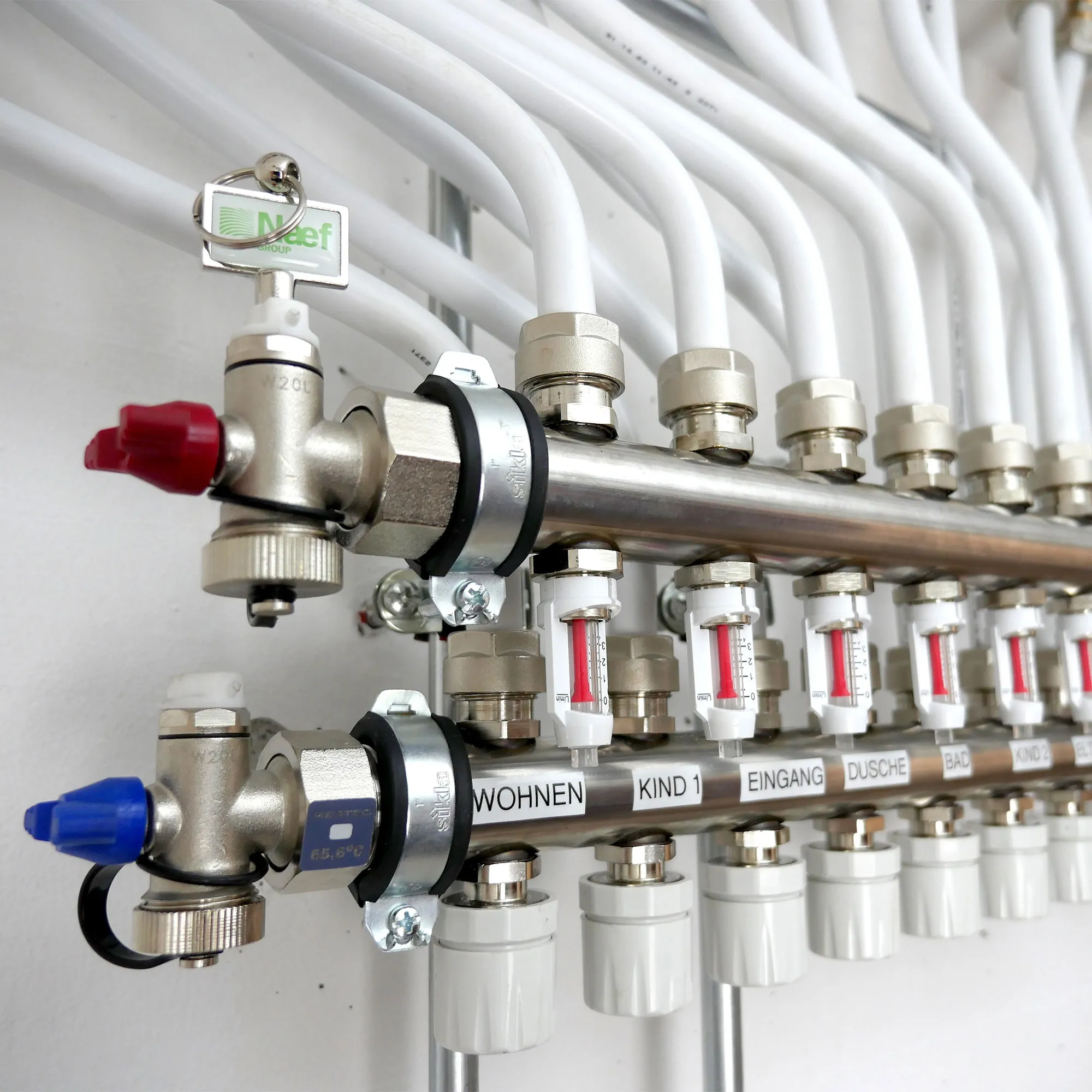 A bunch of pipes are connected to a wall.