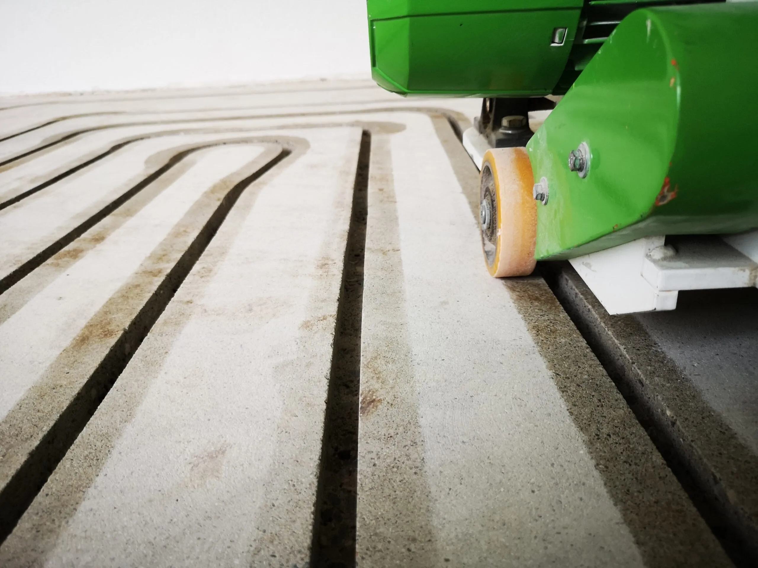 A close up of a machine cutting a piece of wood.