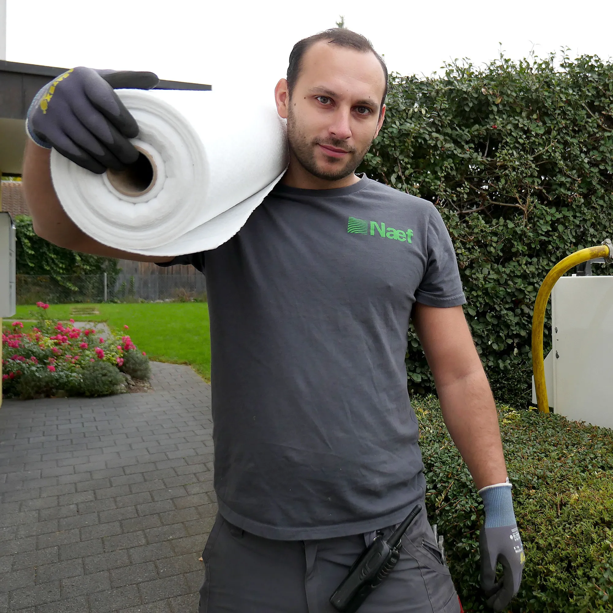 A man holding a roll of toilet paper.