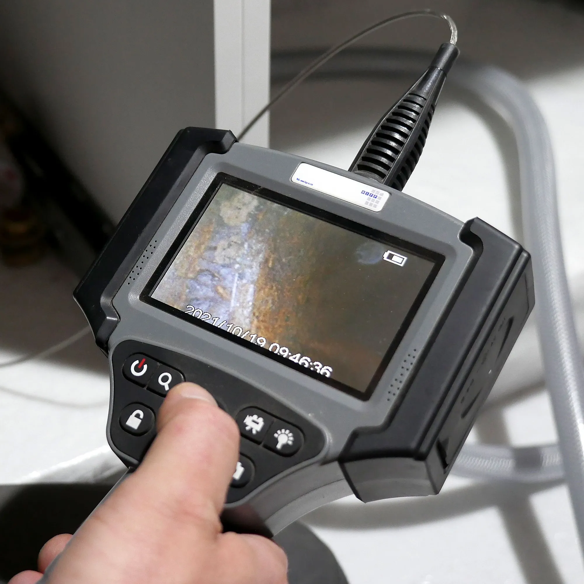 A hand holding a camera with a picture on it.
