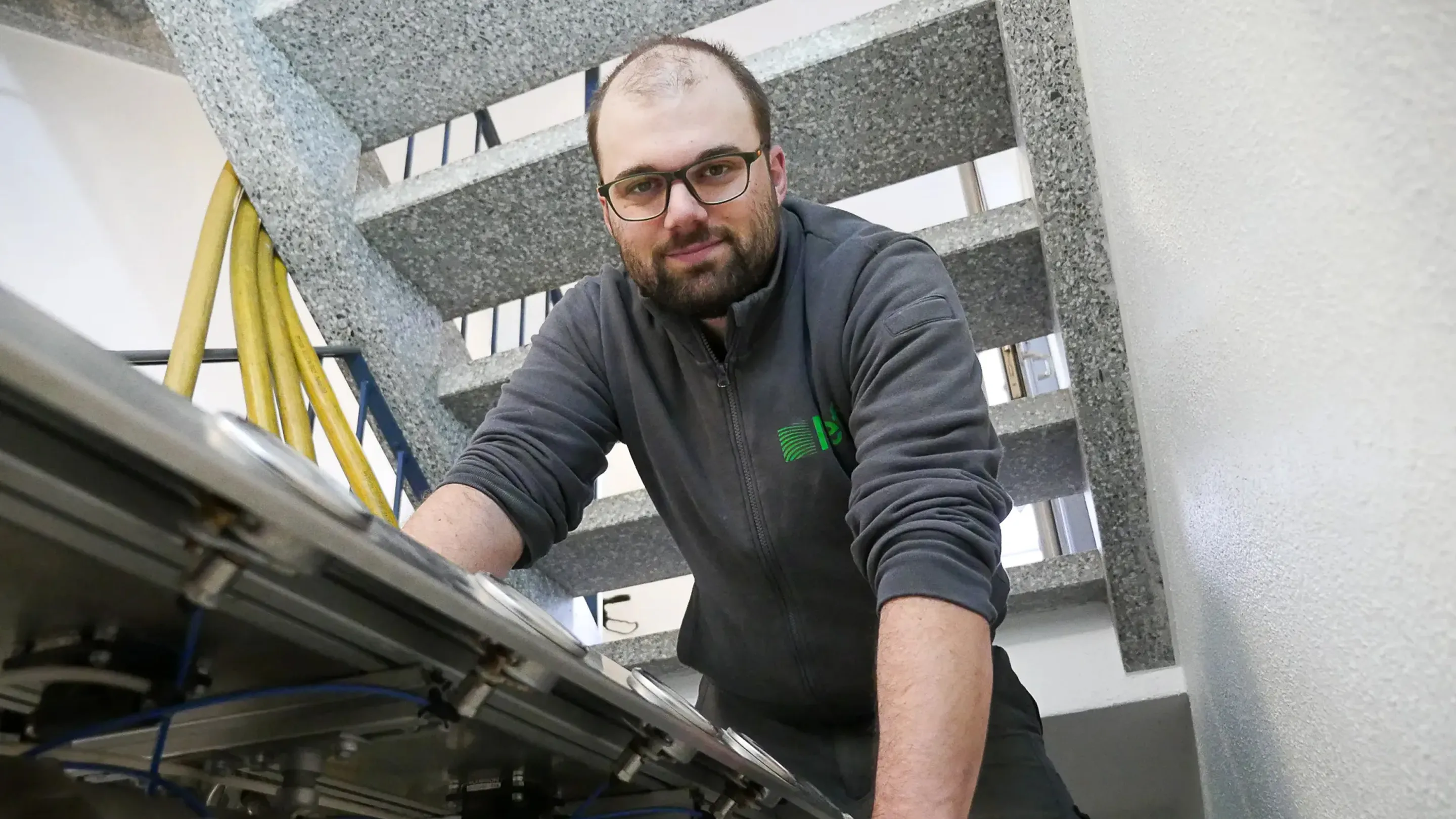 A man working on a machine in a factory.