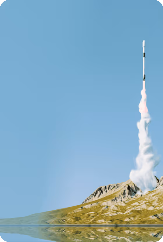 Rocket launching vertically from mountainous terrain under a clear blue sky.