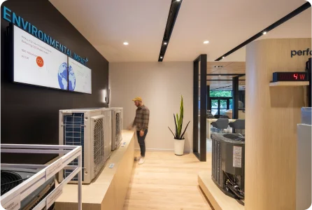Modern office interior with environmental display and person walking