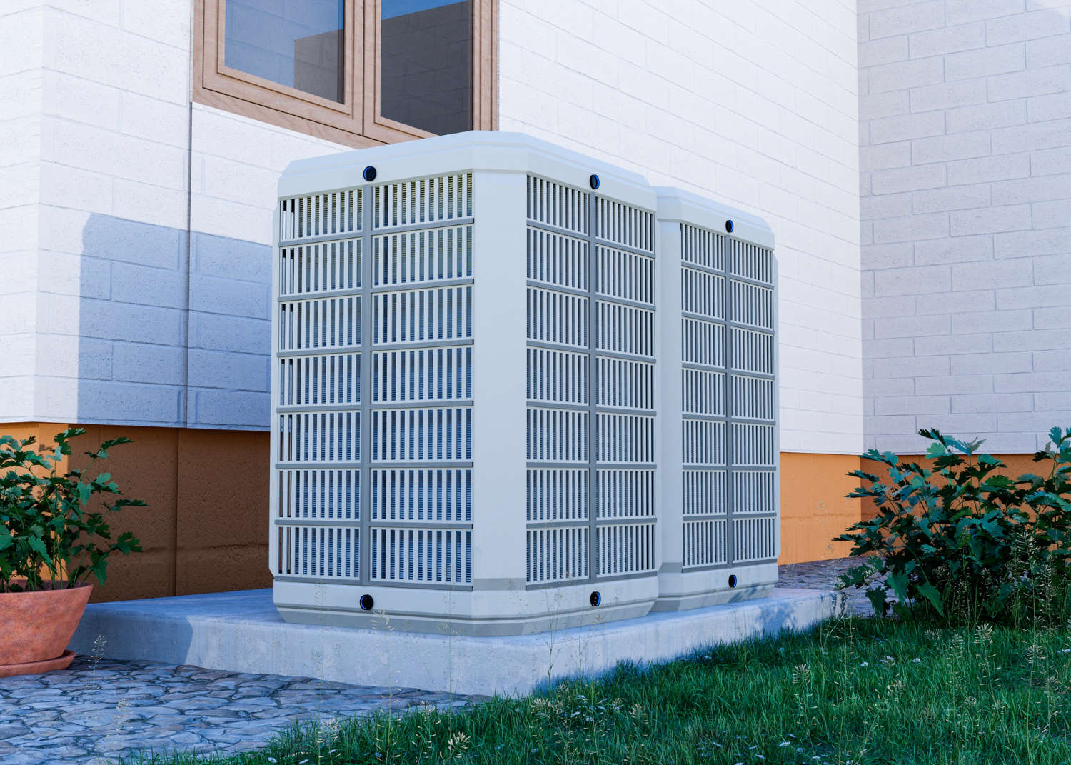 Large white air conditioning unit installed outside near brick wall and grass