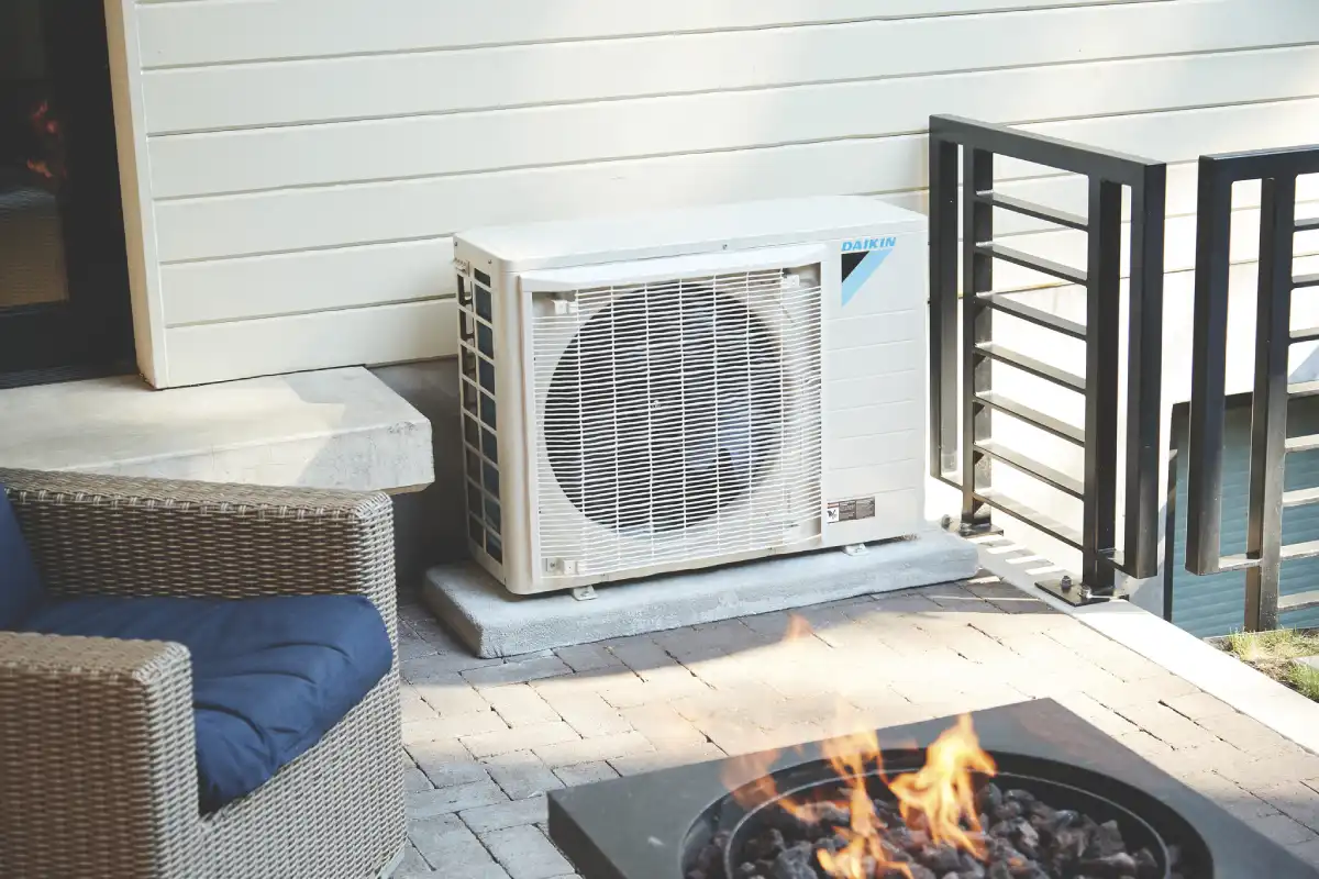 Daikin air conditioner unit near fire pit on outdoor patio