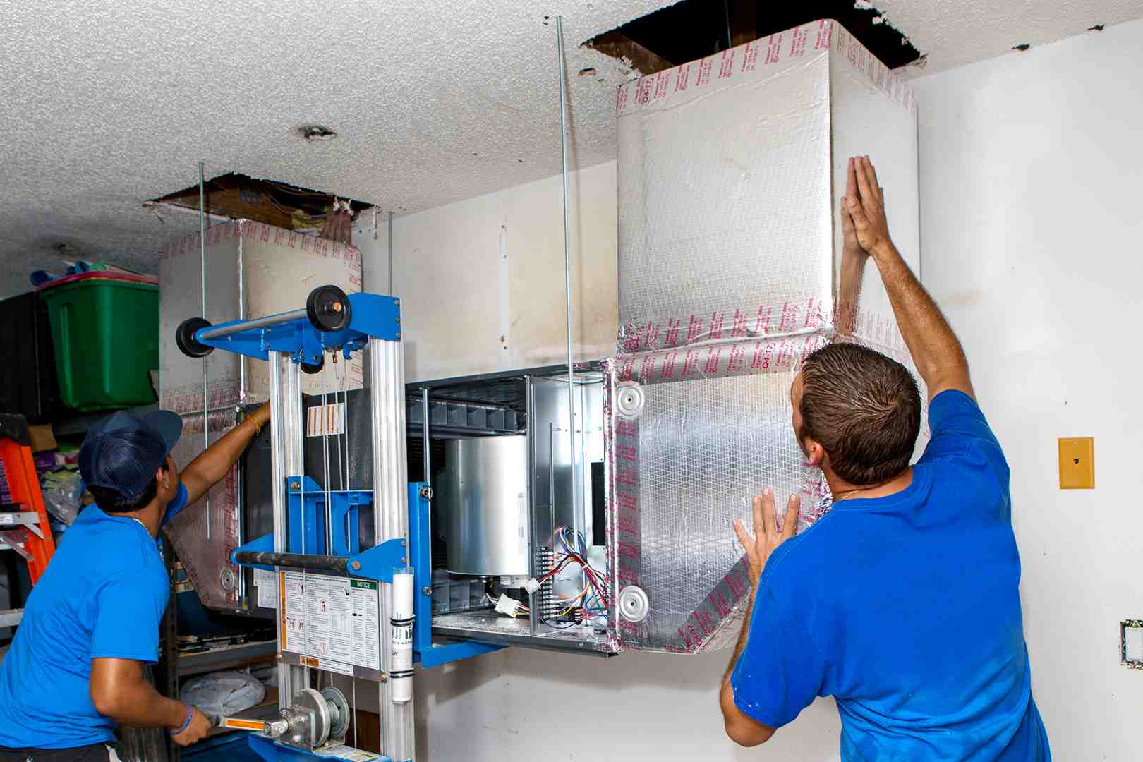 certified technician carefully mounting an indoor unit on a wall - ductless mini split installation seattle wa certified technician carefully mounting an indoor unit on a wall - ductless mini split installation seattle wa