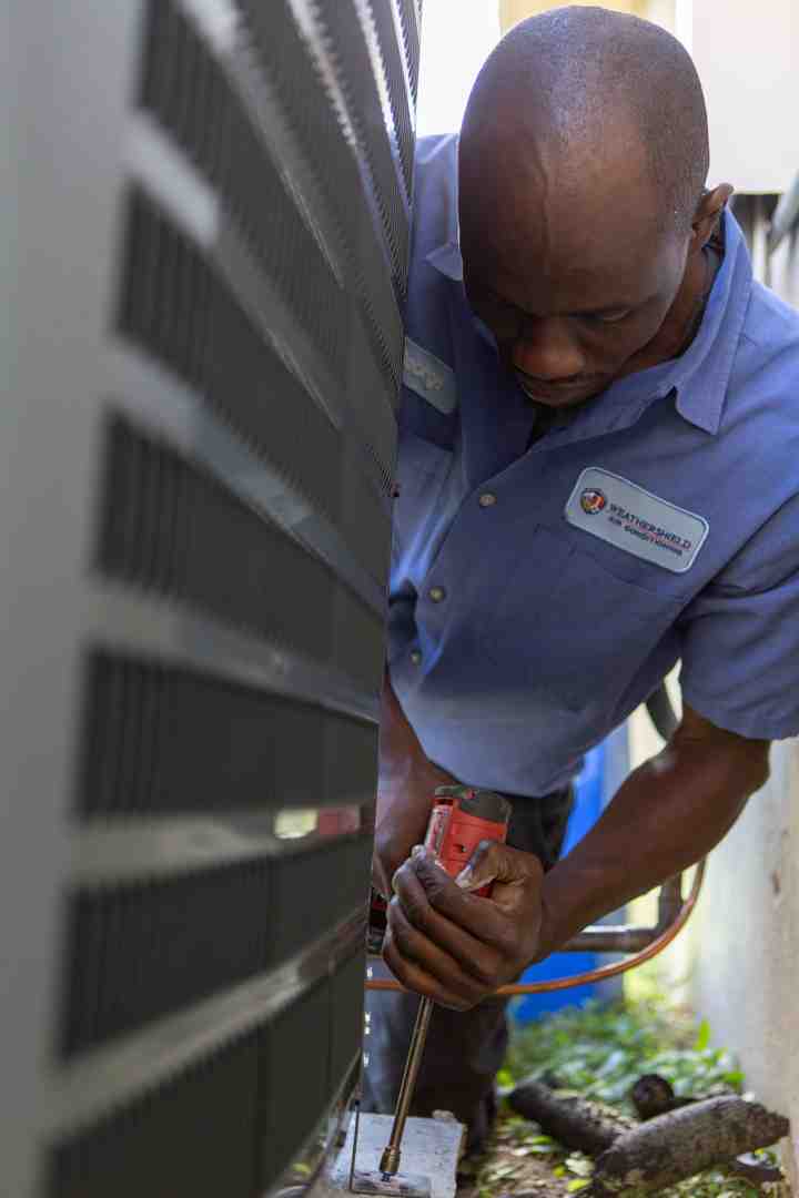 HVAC technician performing maintenance - best mini split for seattle climate HVAC technician performing maintenance - best mini split for seattle climate