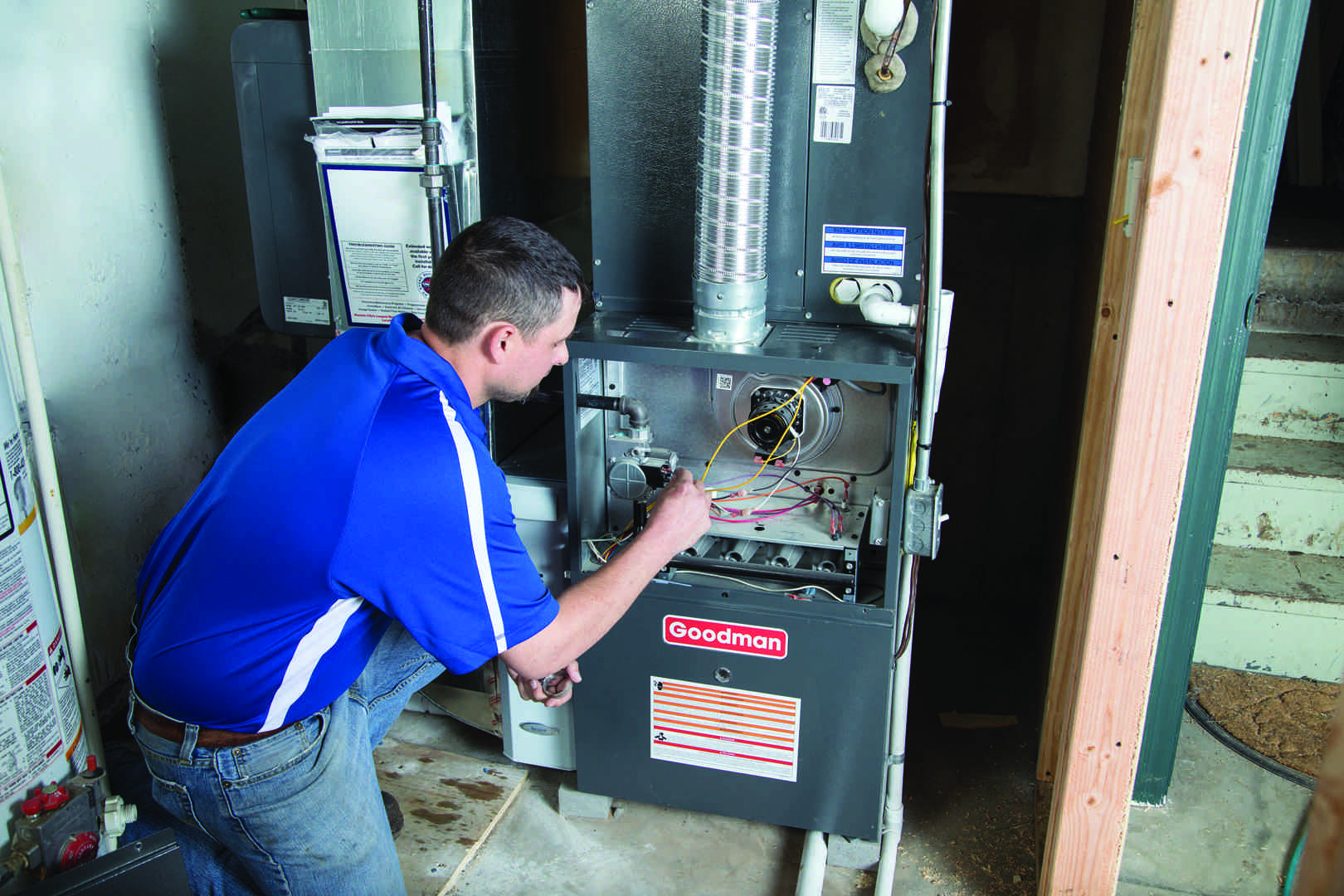 a technician examining the internal components of a furnace - hvac inspection seattle wa