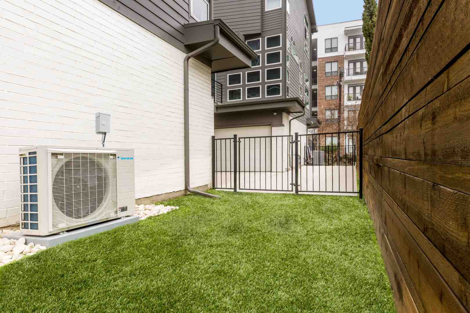 homeowner looking concerned at outdoor heat pump unit - heat pumps inspection in medina wa homeowner looking concerned at outdoor heat pump unit - heat pumps inspection in medina wa