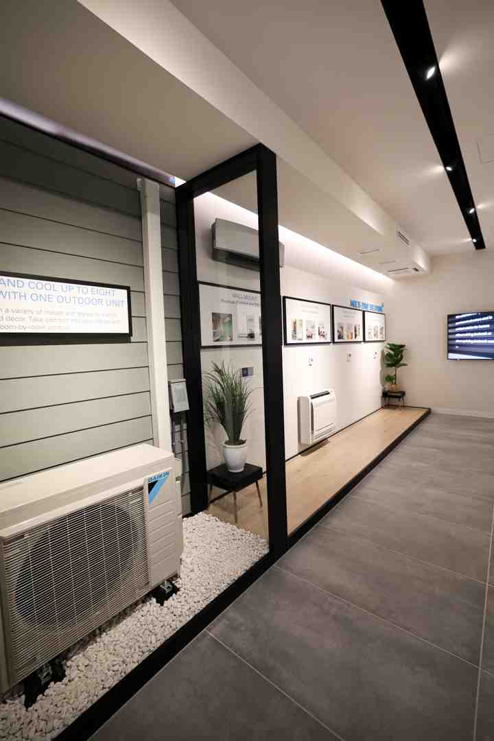 A technician installing a Daikin floor mount unit in a room with floor-to-ceiling windows - daikin floor mount unit benefits A technician installing a Daikin floor mount unit in a room with floor-to-ceiling windows - daikin floor mount unit benefits