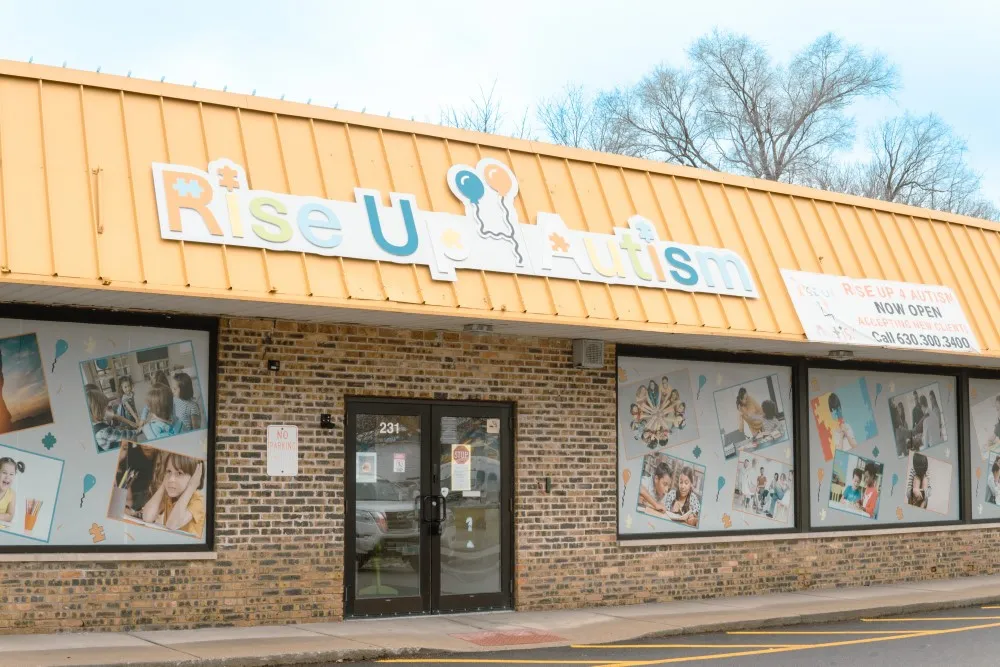 Entrance of Rise Up Autism with colorful signage and decorated windows.