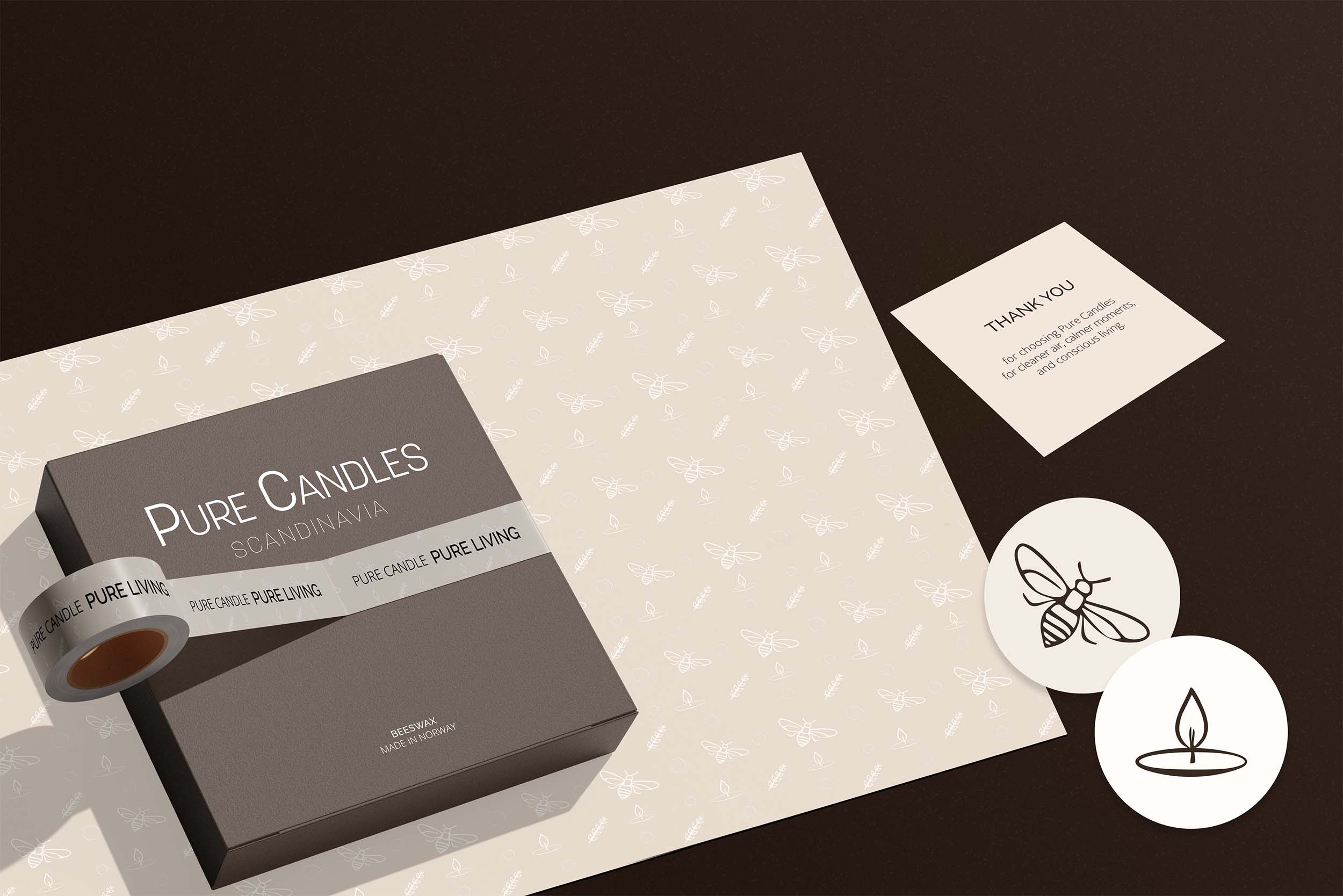 Flat lay featuring Pure Candles packaging with wrapping paper, a thank you card, and decorative stickers.
