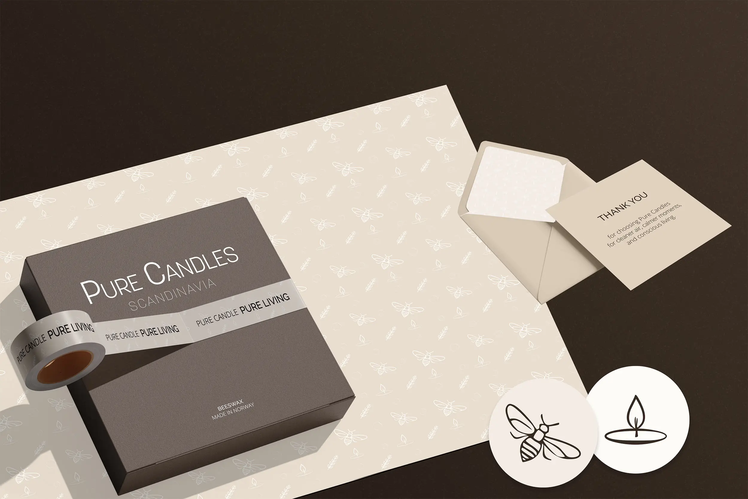 Flat lay featuring Pure Candles packaging with wrapping paper, a thank you card, and decorative stickers.
