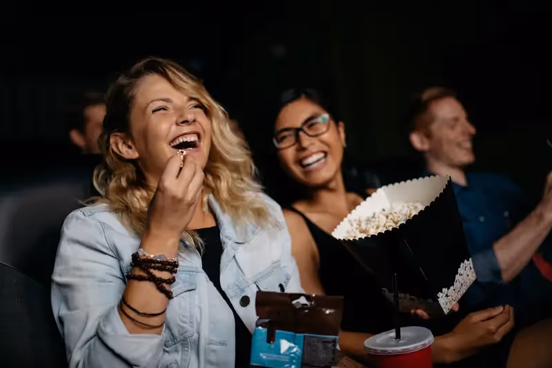 friends laughing in movie theater
