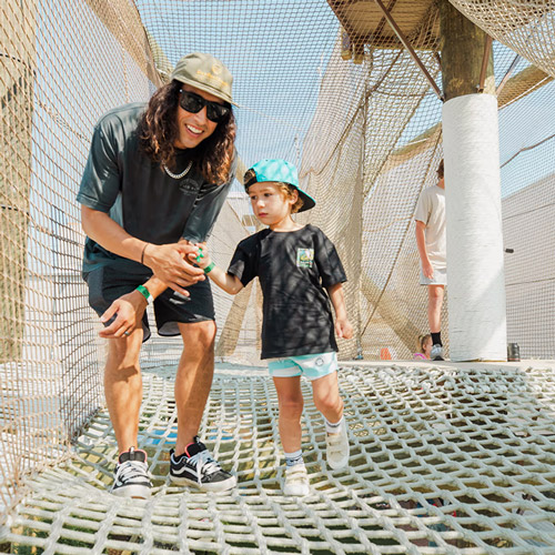Man and child bonding on the netted sky playground at The Yard Ocean City NJ adventure park